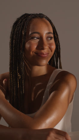 Studio-Beauty-Shot-Of-Smiling-Young-Woman-With-Long-Braided-Hair-Against-Neutral-Background-4